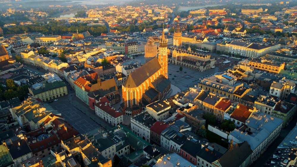 A krakkói Mária-templom (Bazylika Mariacka) és a Fő tér (Rynek Główny) látható a képen naplementekor.  - Z(s)eppelin utazás